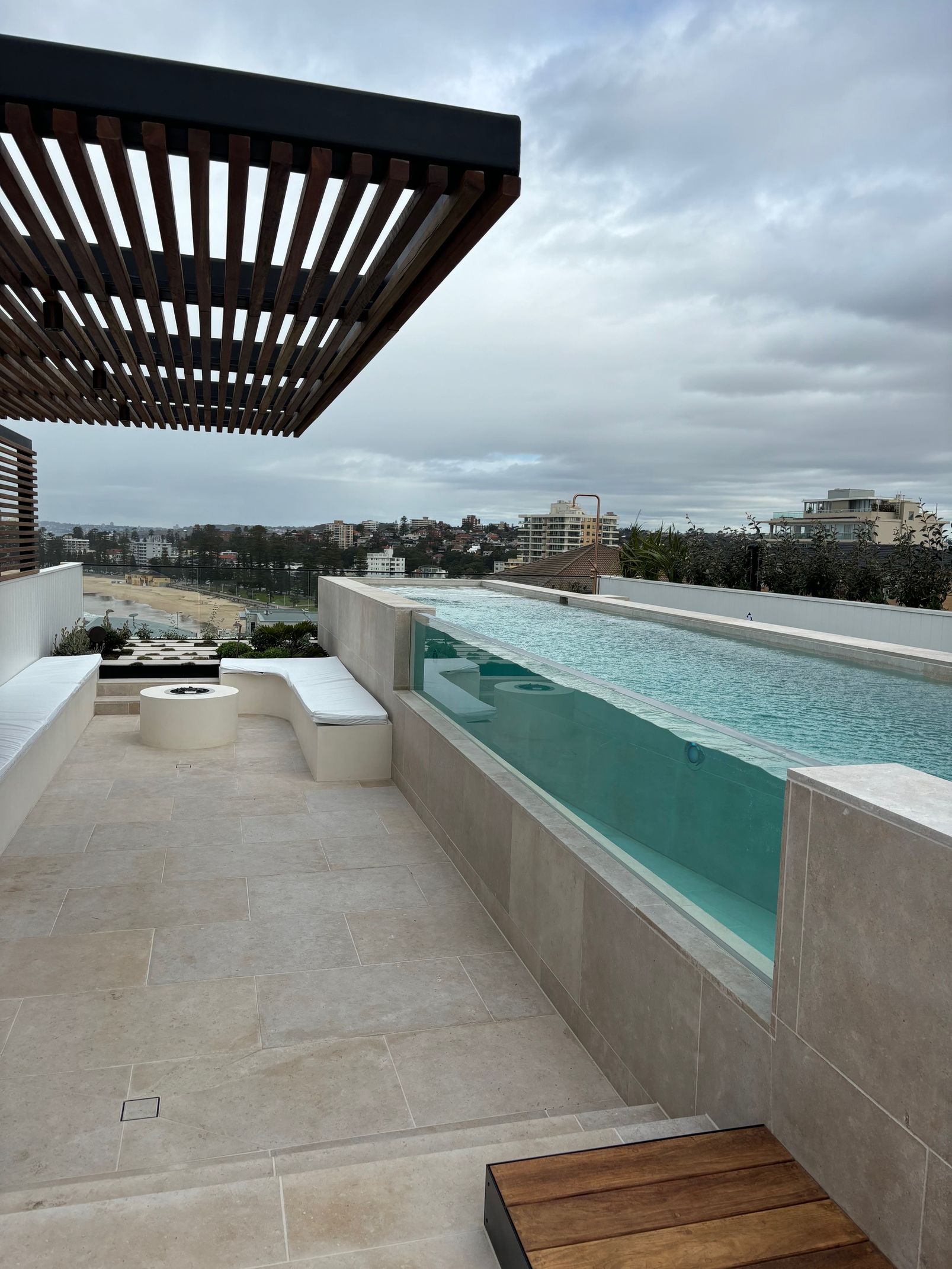 A swimming pool on a rooftop with a view of the city