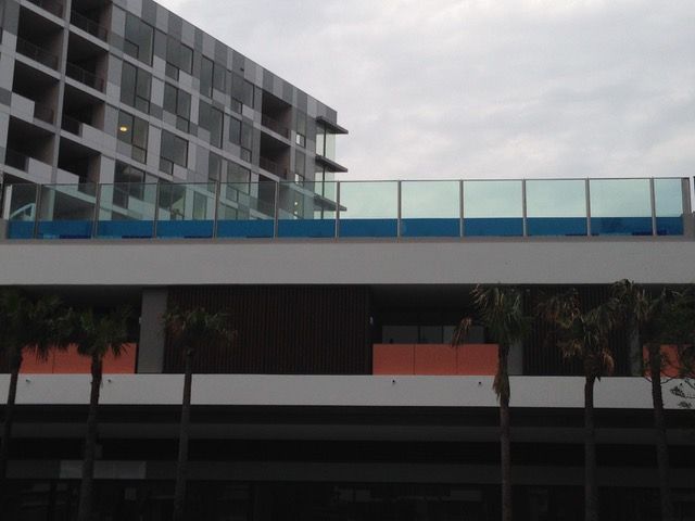 A building with a glass railing on the side of it
