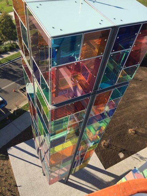 An aerial view of a building with rainbow colored windows