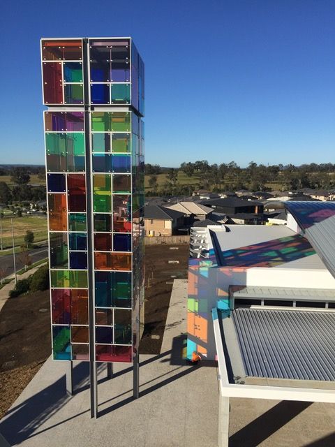 A building with a stained glass tower on top of it