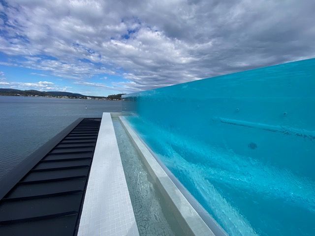 A swimming pool with a view of a body of water