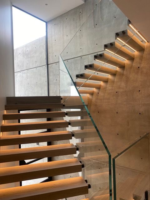 A staircase with wooden steps and a glass railing