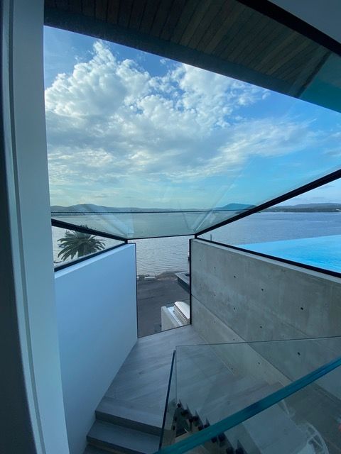 Stairs leading up to a balcony overlooking a body of water