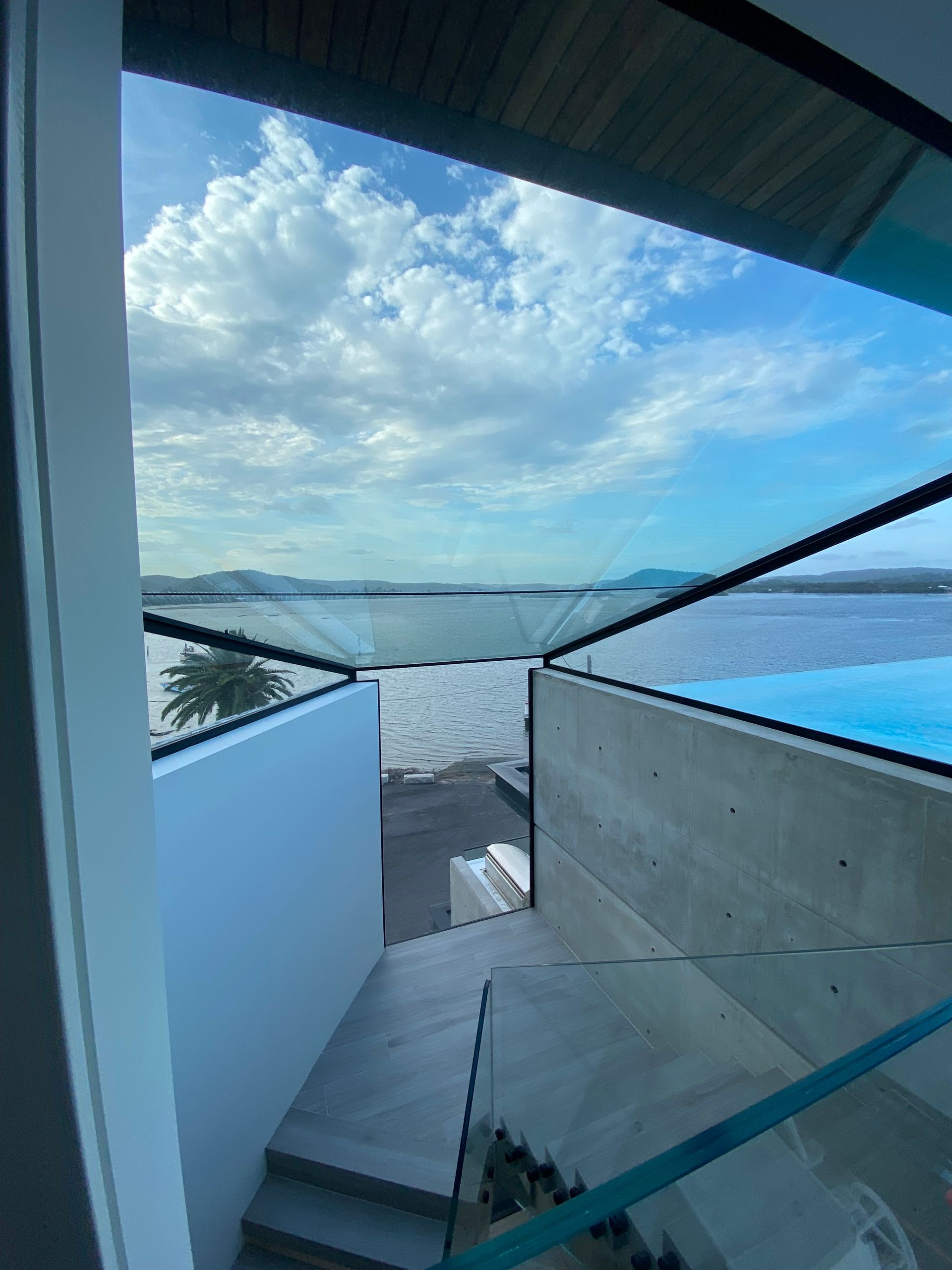 Stairs leading up to a balcony with a view of the ocean