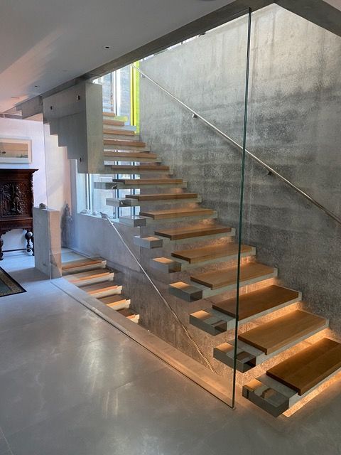 A staircase with wooden steps and a glass railing