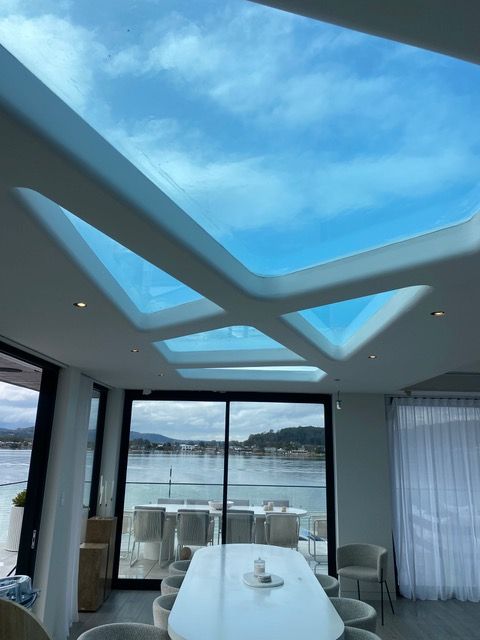 A room with a table and chairs and a skylight