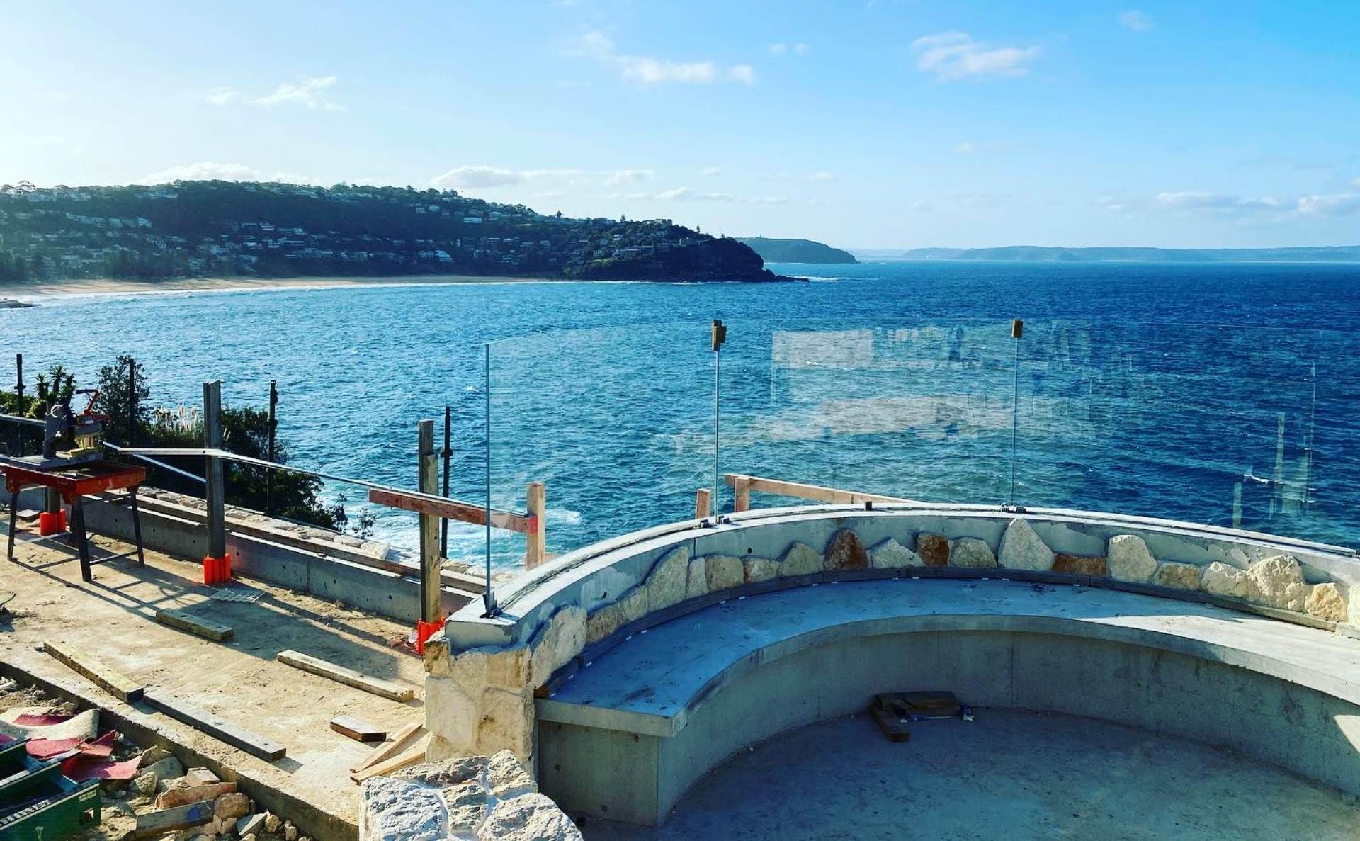 There is a bench in the middle of the ocean with a view of the ocean.