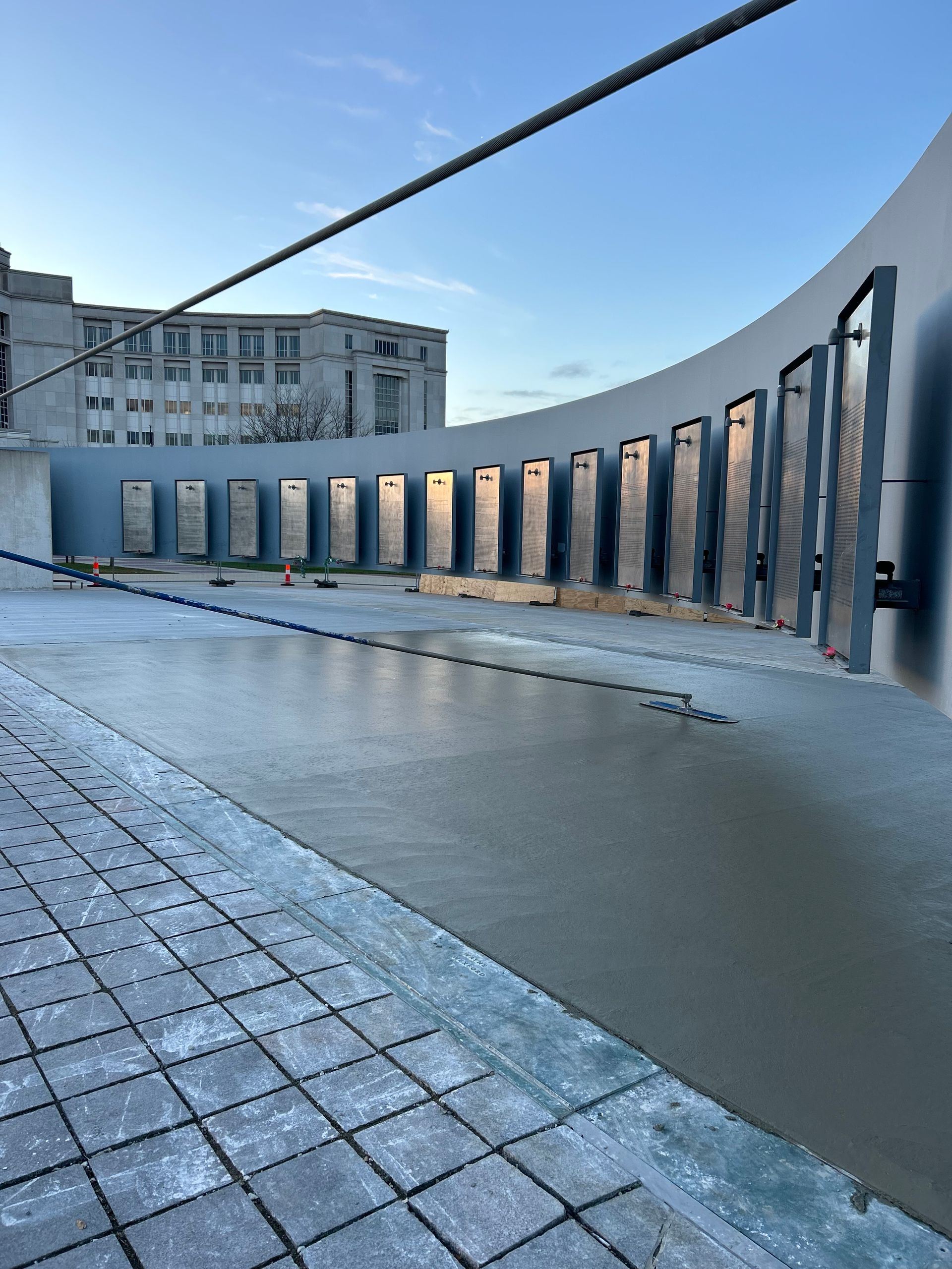 A concrete walkway with a building in the background