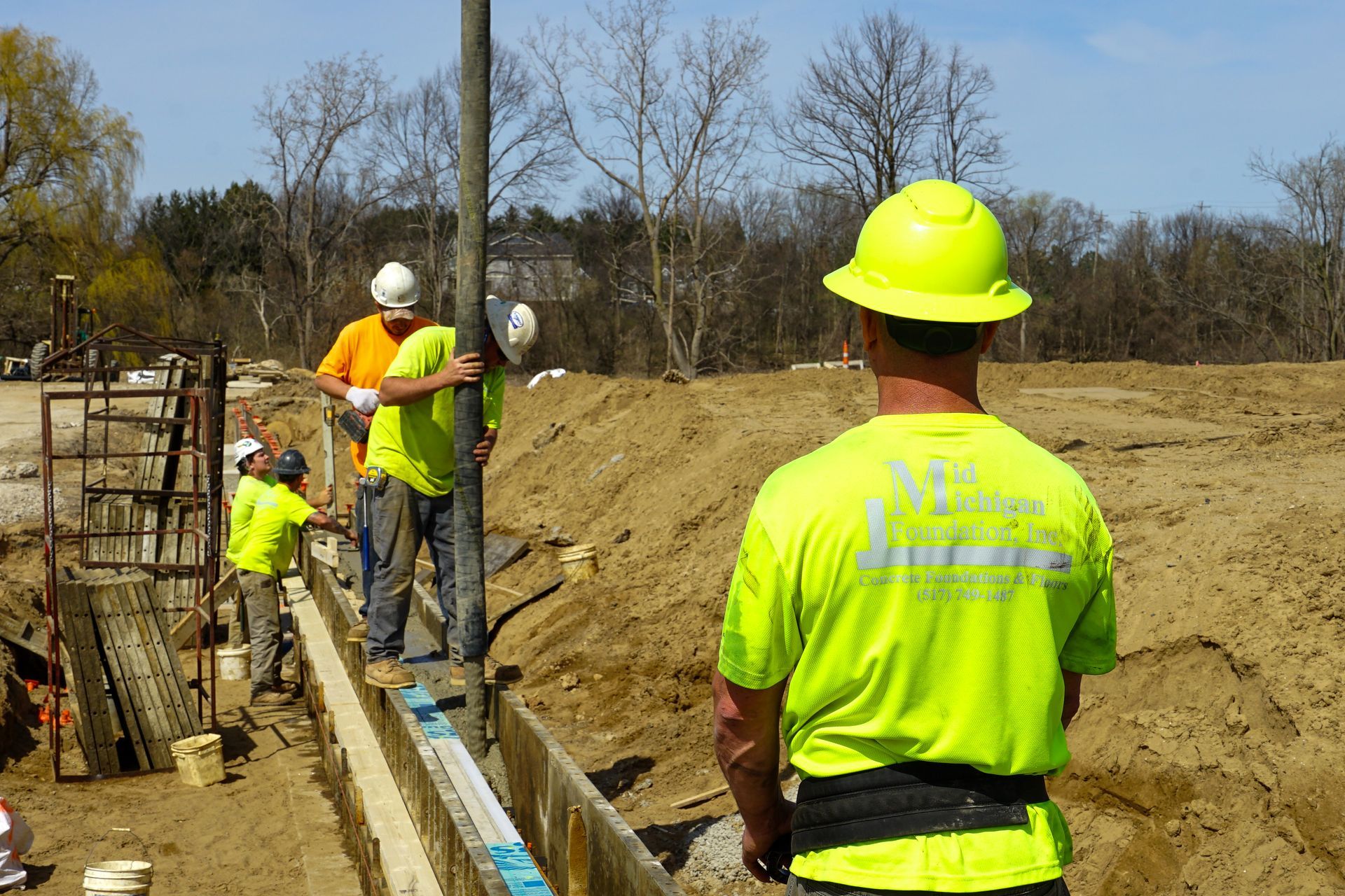 A group of construction workers are working on a construction site.