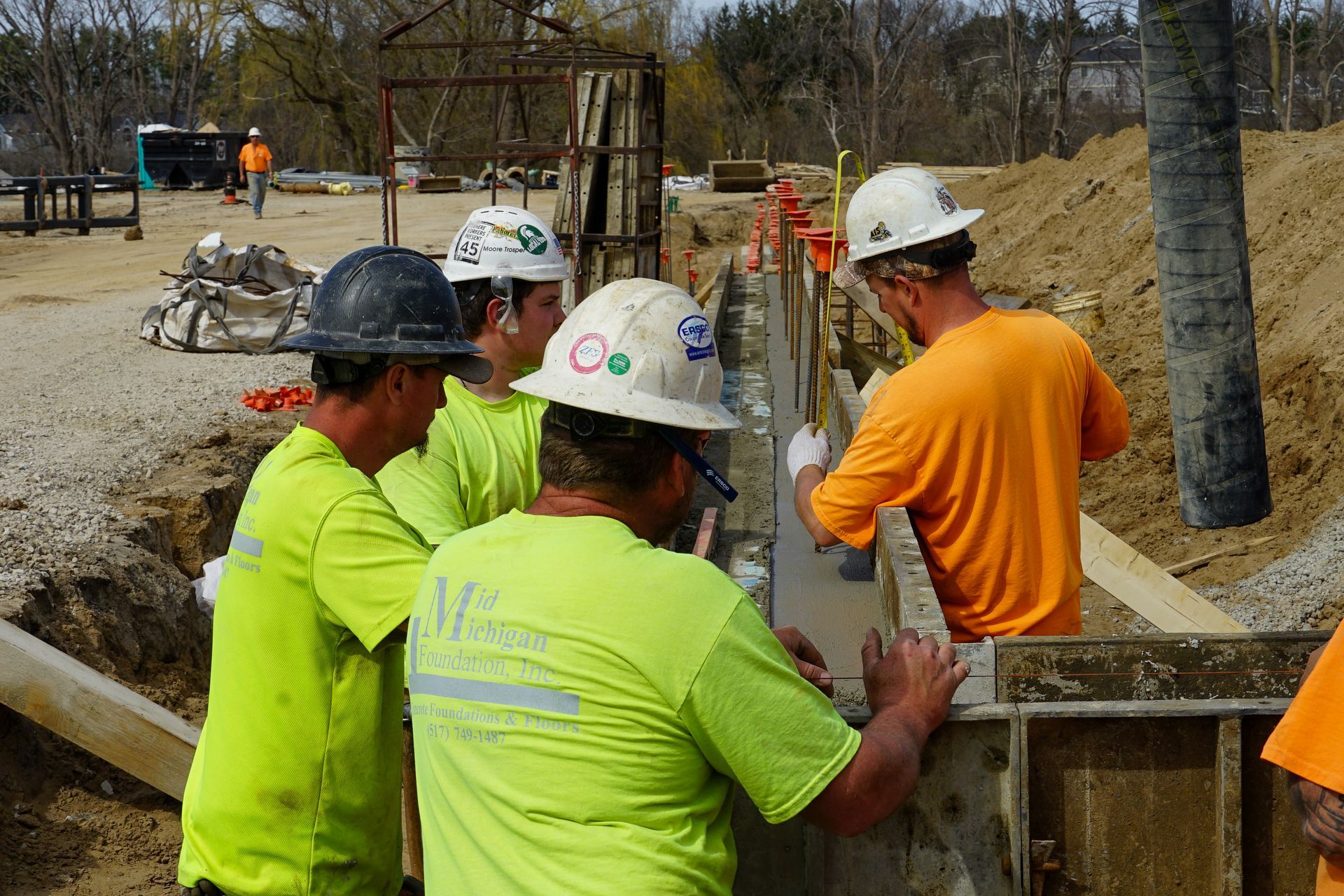 A group of construction workers are working on a construction site.