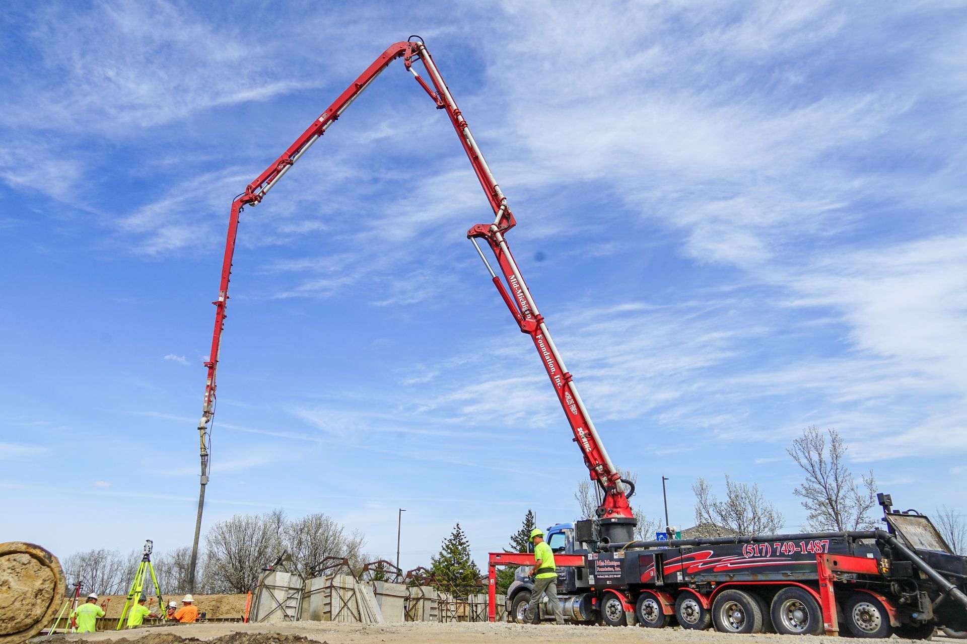 A concrete pump is being used to pump concrete on a construction site.
