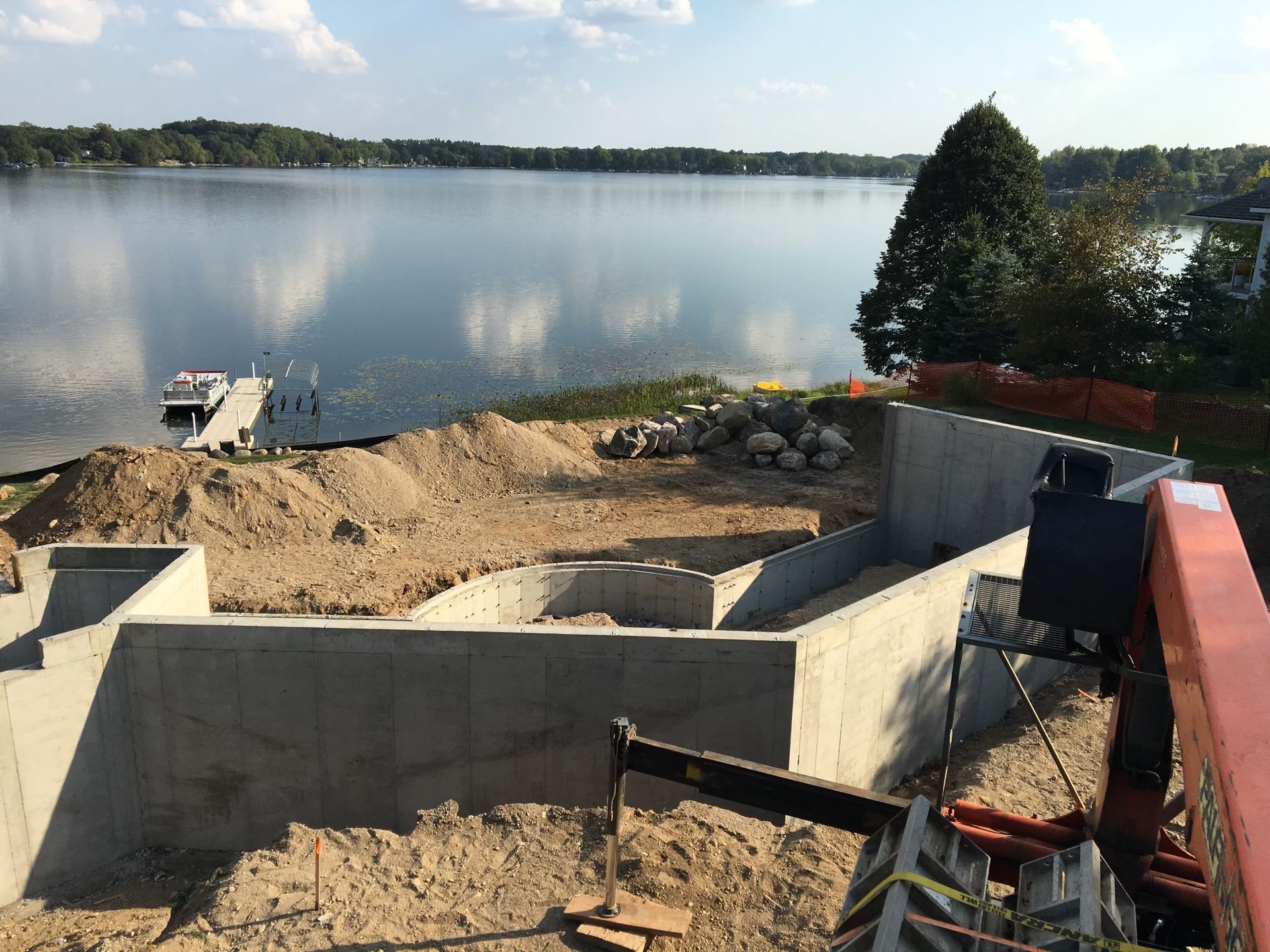 A construction site with a large body of water in the background.