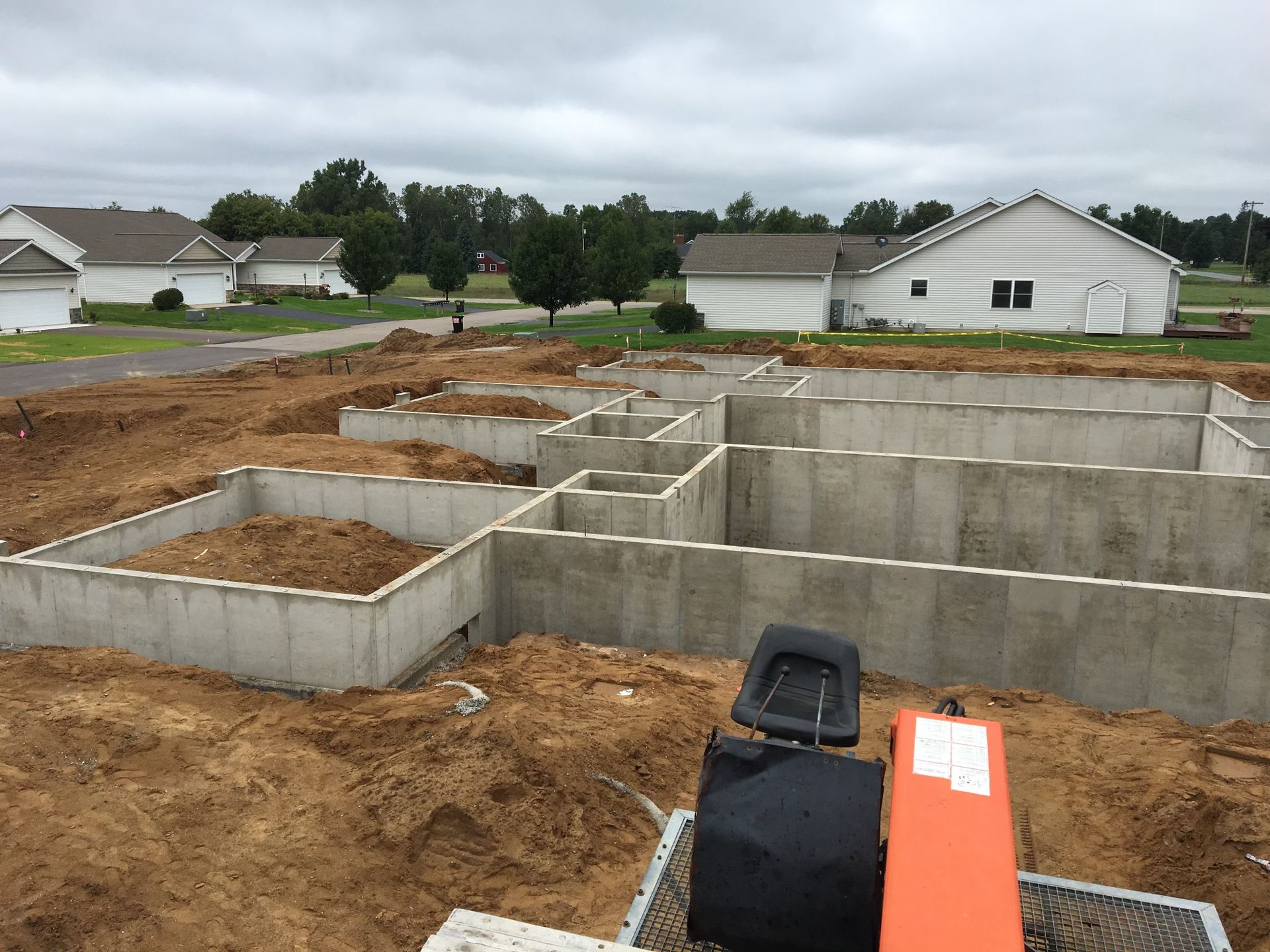A concrete foundation is being built in a residential area