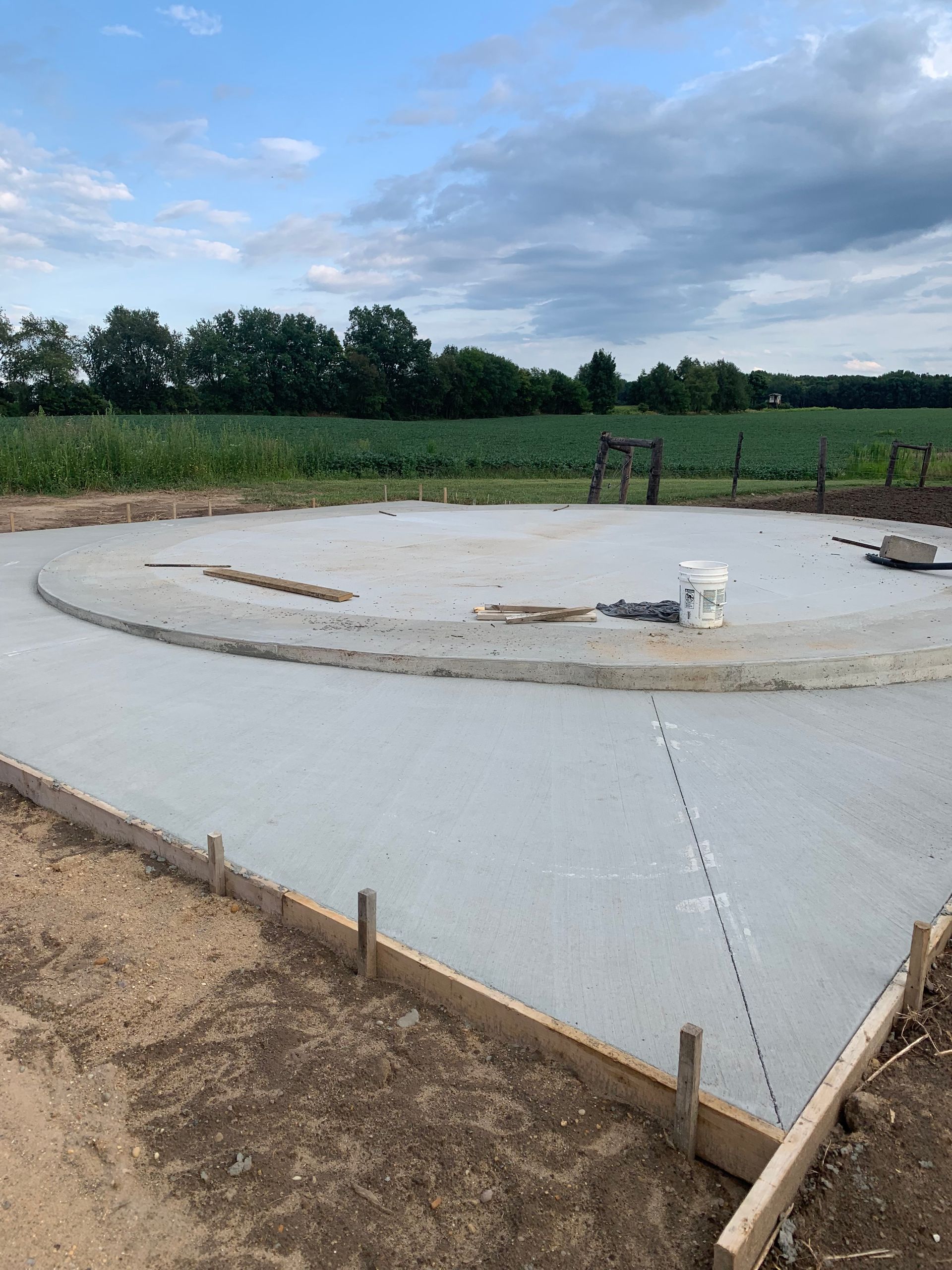 A concrete foundation is being built in a field.
