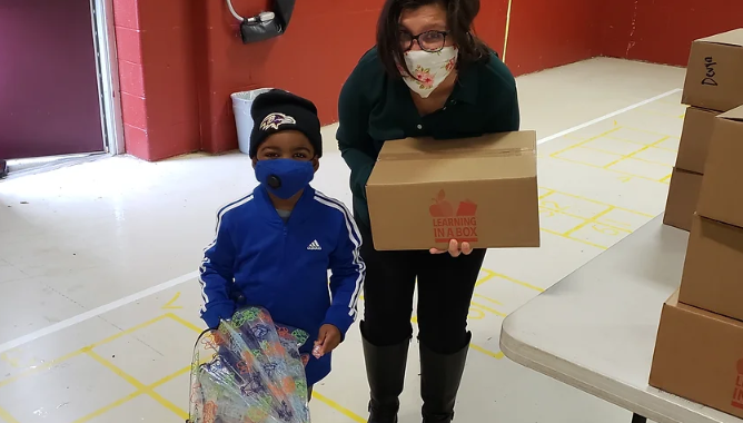 Student and Principal with Learning in a Box Kit