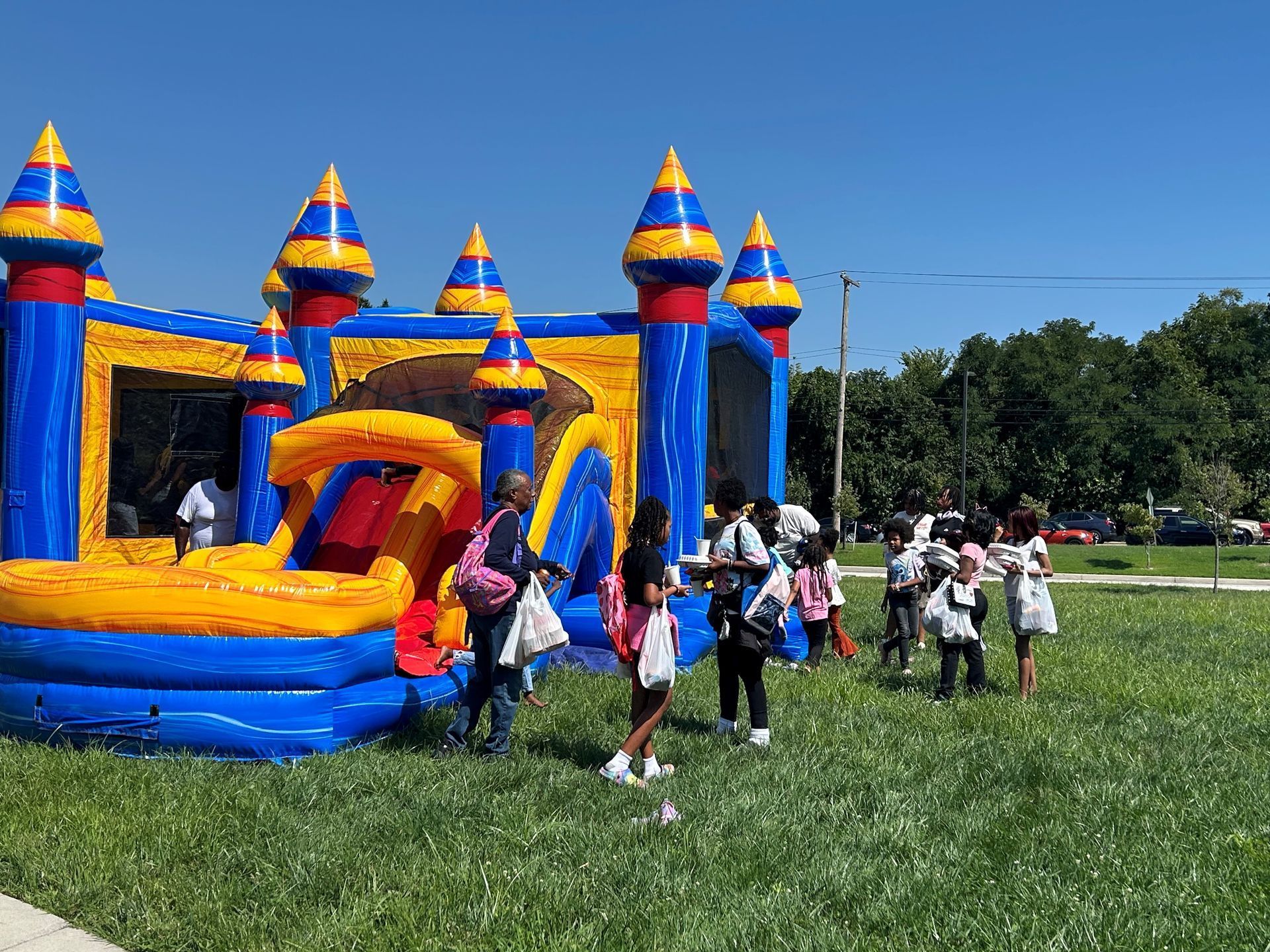 Kids and parents  playing on a moon bounce