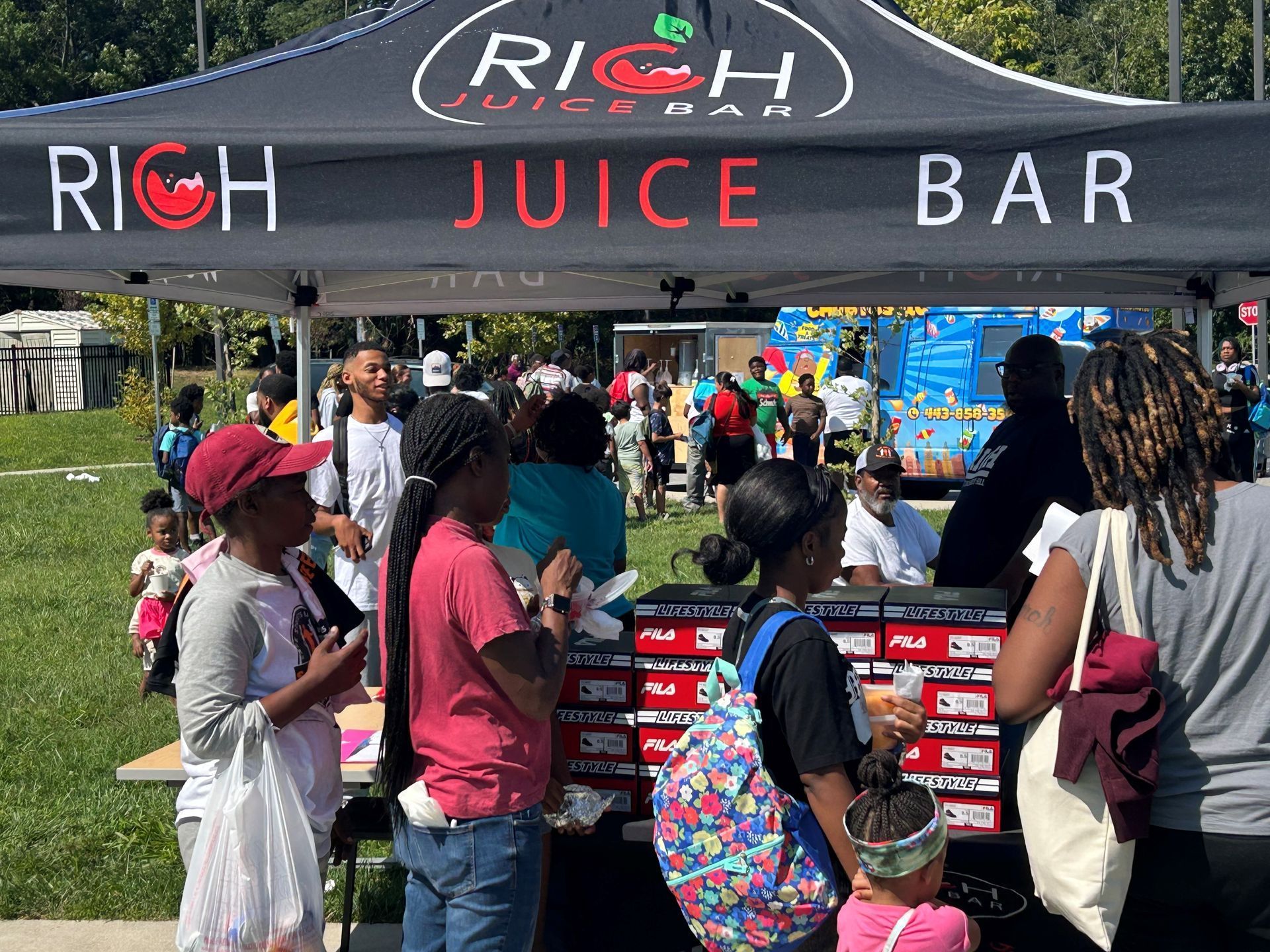 People outside of juice bar tent