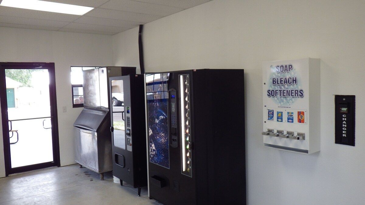 A row of vending machines are lined up in a room.