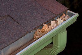 Downspouts — Gutter full of leaves in Savage, MN