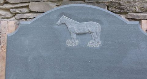 Green slate memorial with hand carved horse