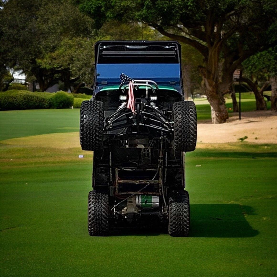 A golf cart is sitting on top of a lush green golf course.