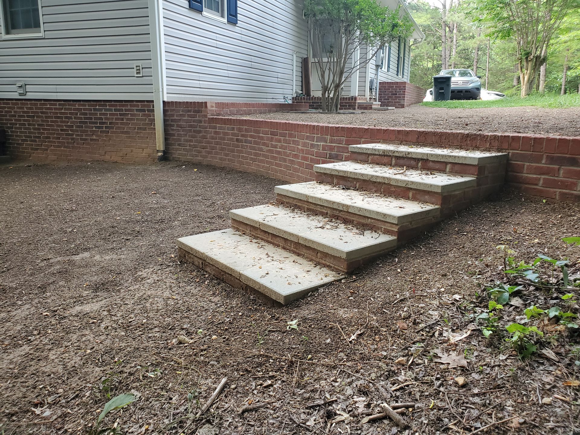 A set of concrete steps leading up to a house.