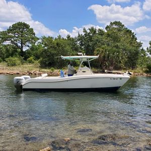 A white boat is floating on top of a body of water.