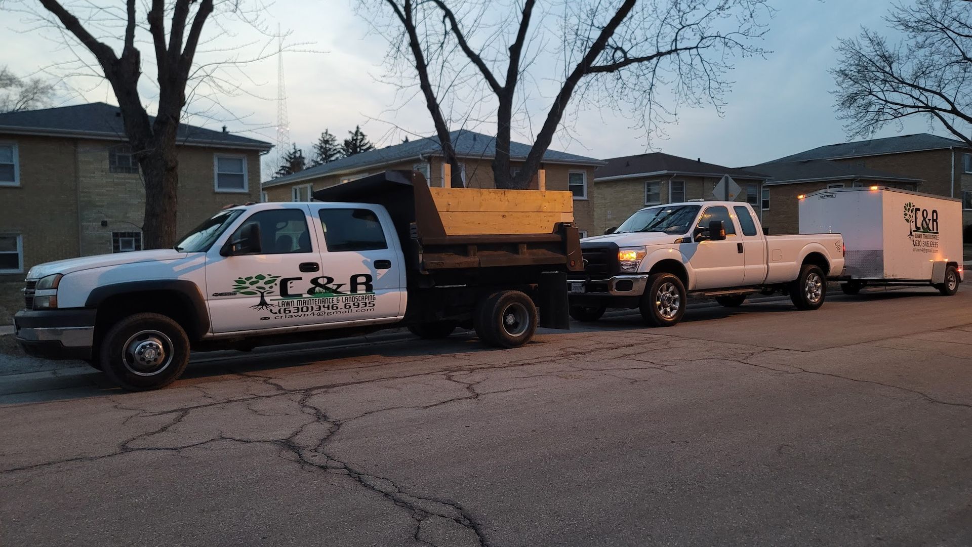 A couple of trucks are parked on the side of the road.