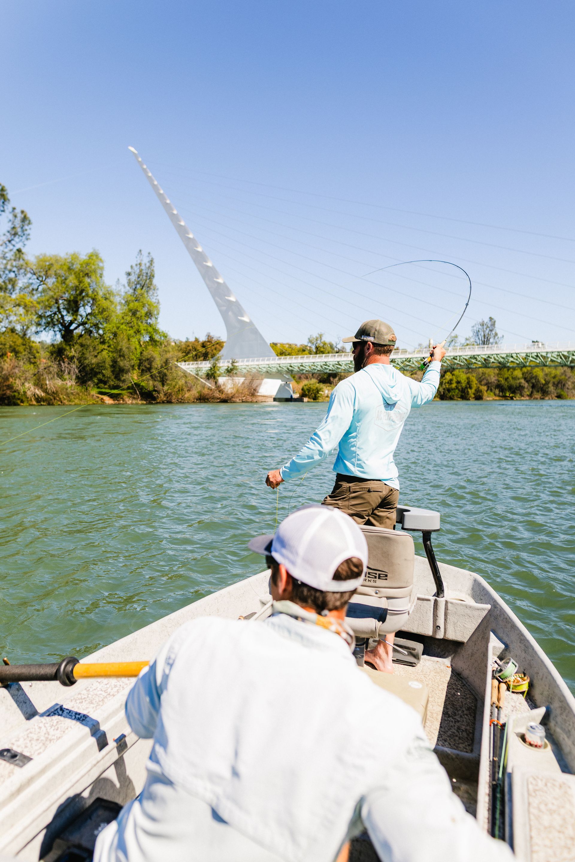 Angler fly fishing on California’s Lower Sacramento River with a professional guide