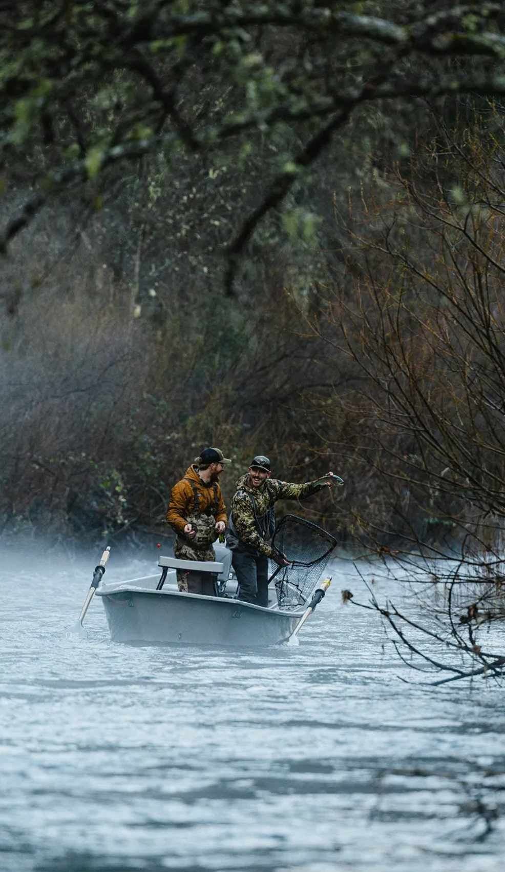 Fly fisherman hooked into a steelhead on the Trinity River in Northern California