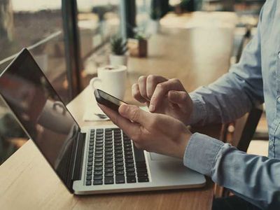 hands holding smartphone in cafe