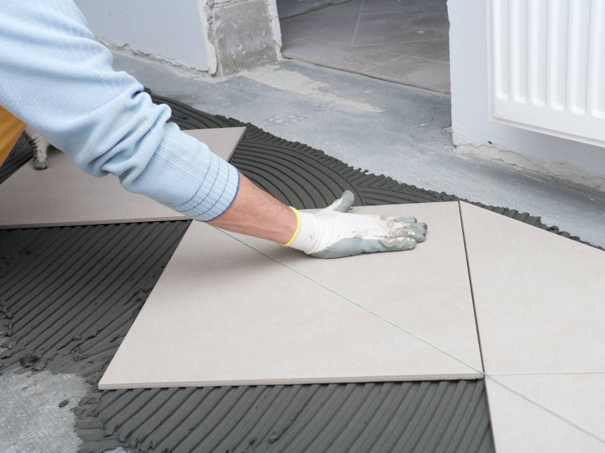 Derbyshire Flooring Specialists floor tilers installing beige floor tiles