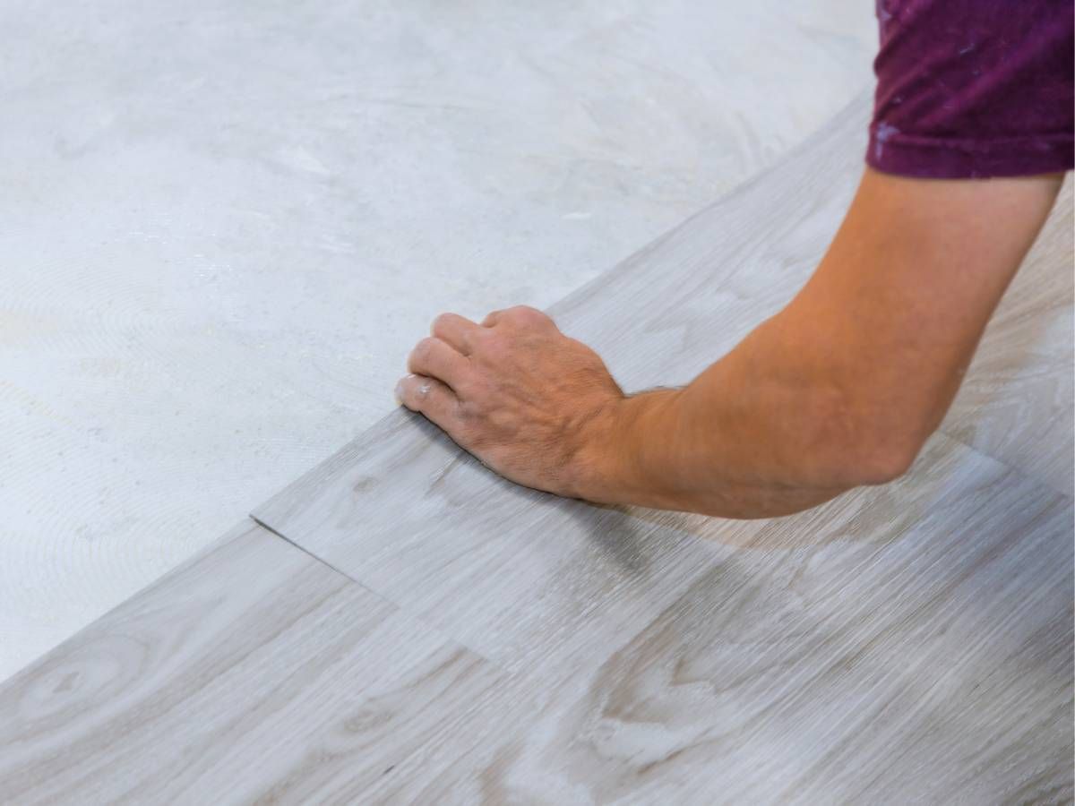 Derbyshire Flooring Specialists fitting ceramic floor tiles in a kitchen in Ripley