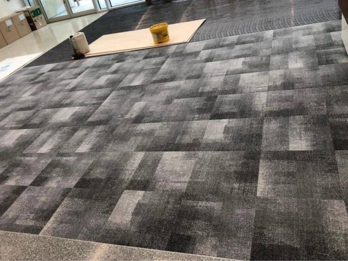 Derbyshire Flooring Specialists fitting carpet tiles for a business in Ripley