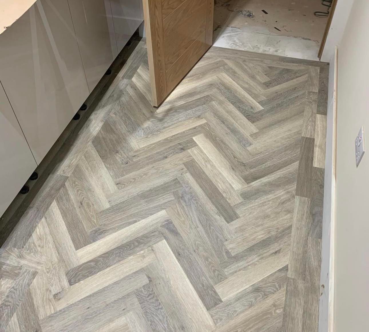 herringbone flooring installed in a hallway for a house in Derby