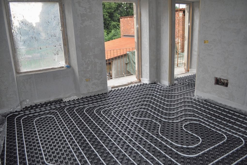 Derbyshire Flooring Specialists laying out the wire for an electric underfloor heating installation in a living room in Derby