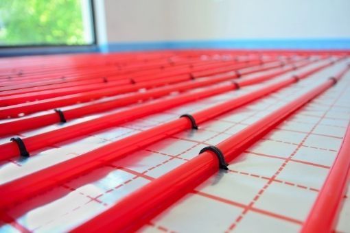 Derbyshire Flooring Specialists laying our water underfloor heating pipes in a kitchen in Derby