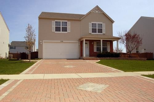 Suburban home with a neatly paved asphalt driveway leading to the front entrance.