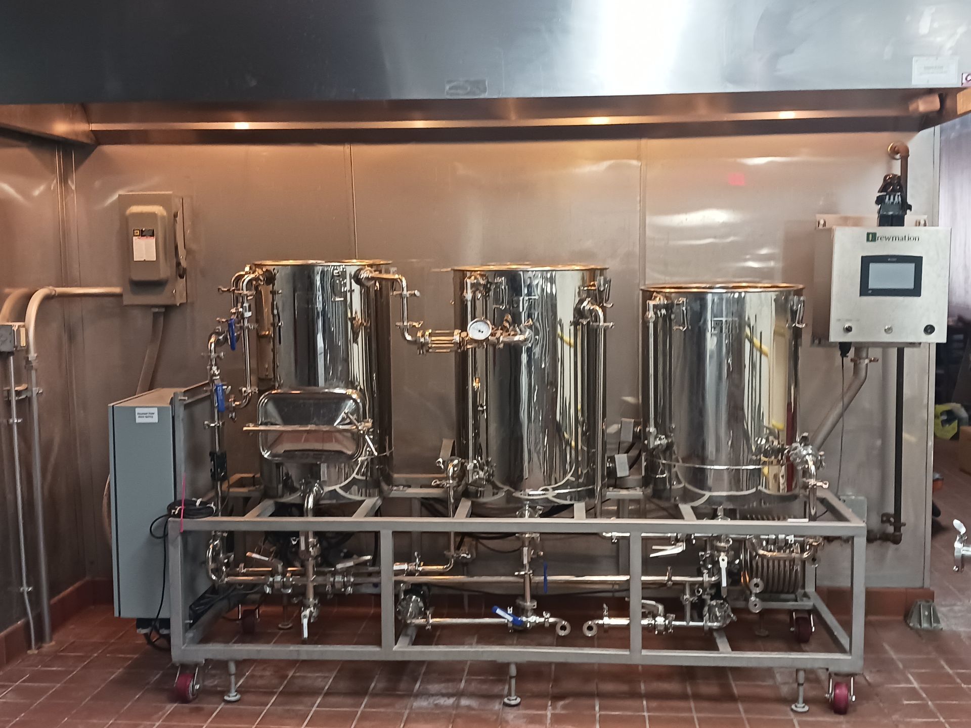 A stainless steel machine is sitting in a kitchen.