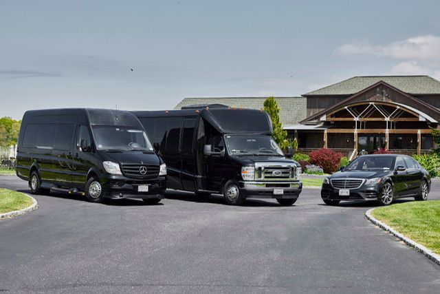 Young couple smiles at each other on a night street, neon lights in the background.
