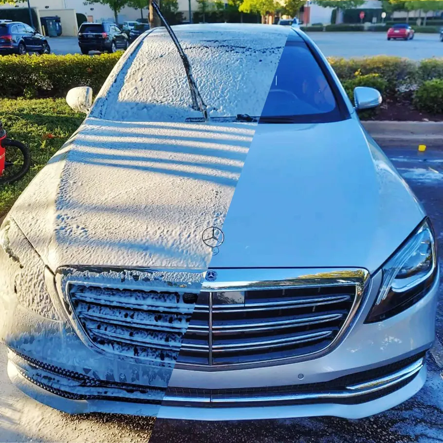 A Mercedes-Benz car, half covered in white foam, the other half clean.