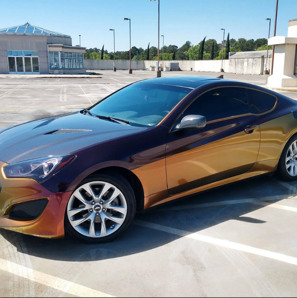 Hyundai Genesis coupe with color-shifting wrap parked on a rooftop parking lot.