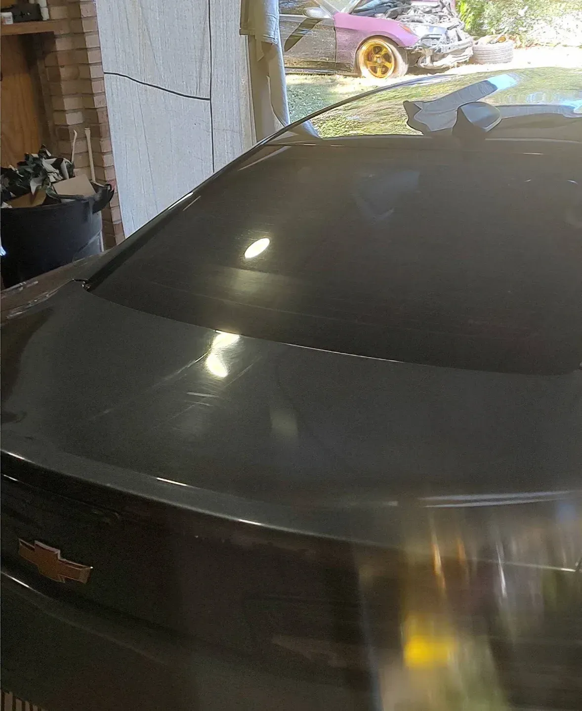 Dark gray car with tinted windows; outdoors.