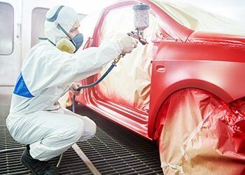 Man Spray Painting Car Red – Automotive paint in Bonville, QLD