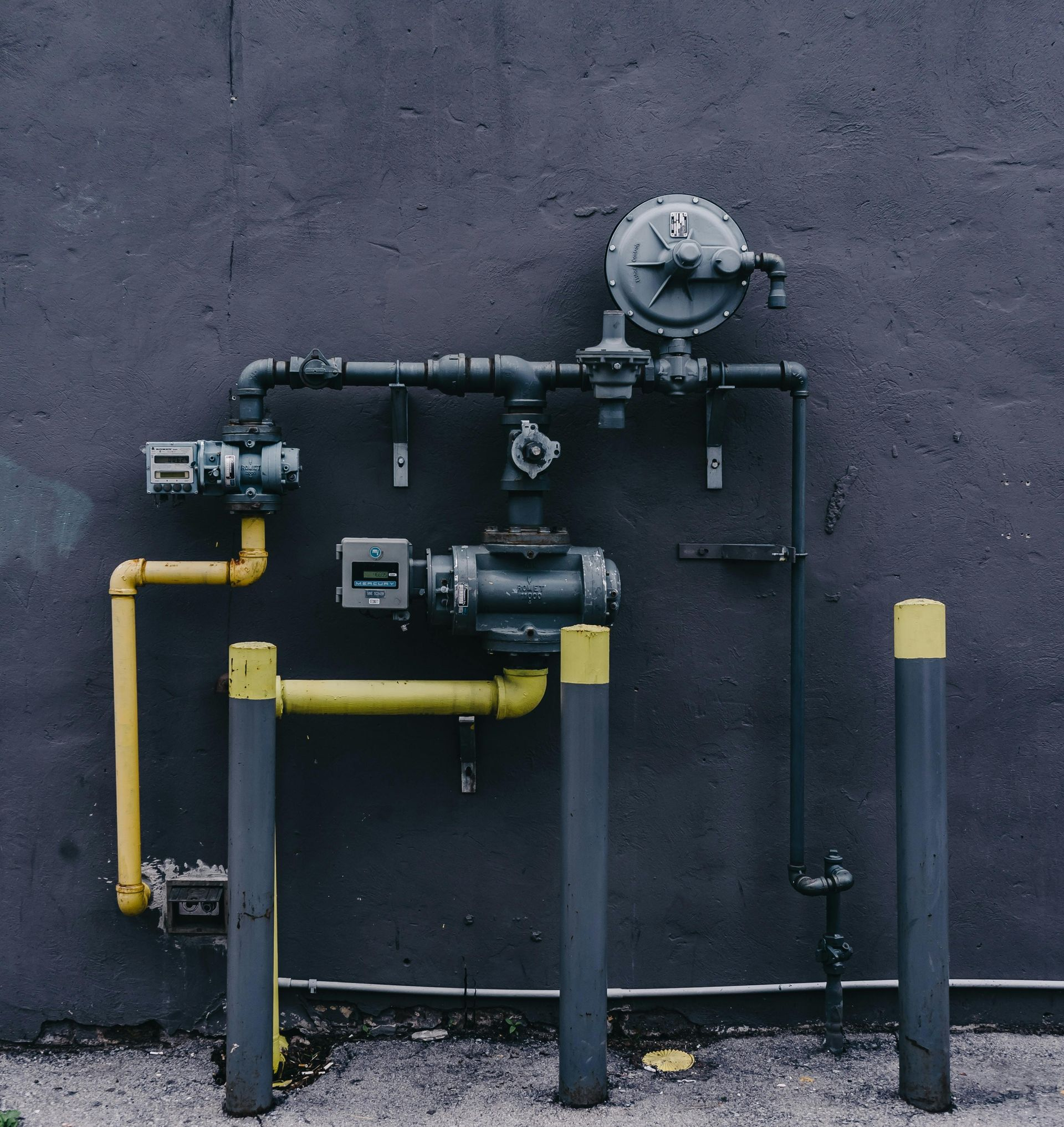 A man is installing a flat screen tv on a wall.