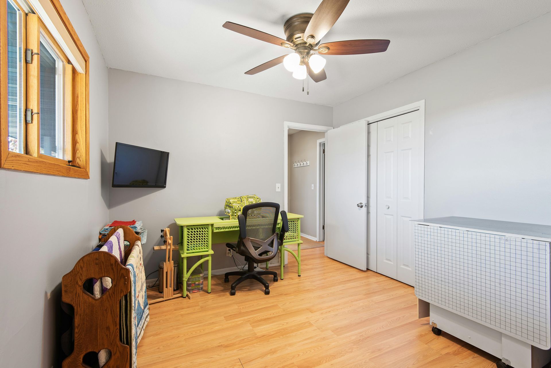 A man is installing a flat screen tv on a wall.