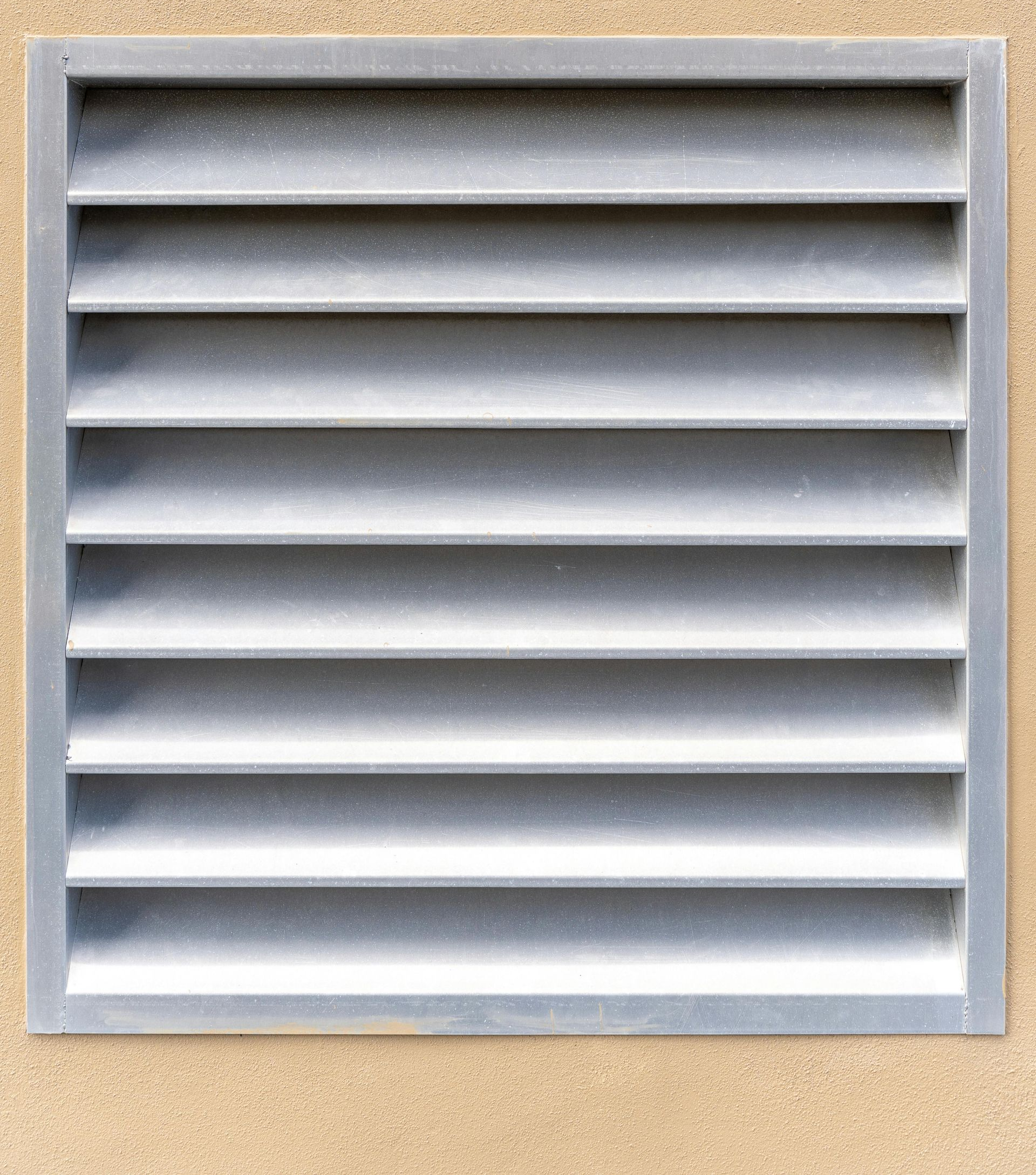 A man is installing a flat screen tv on a wall.