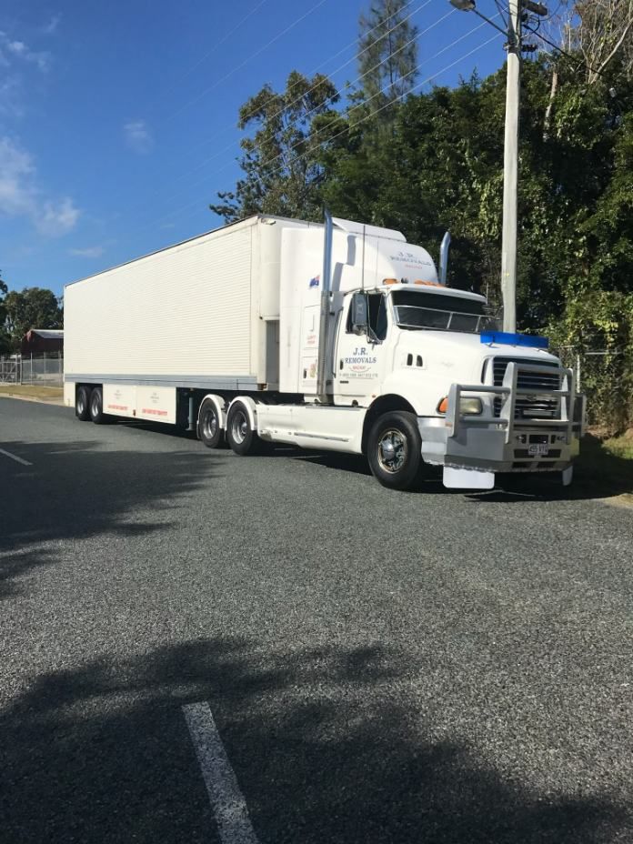 White Semi-truck Parked on a Gray Asphalt Road — JR Removals Mackay In Moranbah, QLD