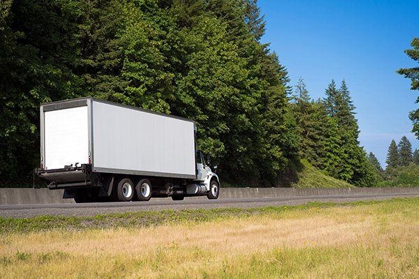 White Truck On The Road — JR Removals Mackay in Mackay, QLD White Truck On The Road — JR Removals Mackay in Mackay, QLD