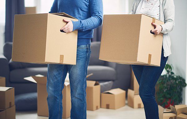 Couple Moving Into New Apartment — JR Removals Mackay in Mackay, QLD Couple Moving Into New Apartment — JR Removals Mackay in Mackay, QLD